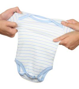 Parents' hands tearing out babysuit, child custody battle