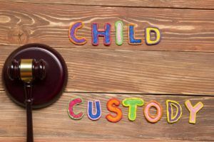 Judge gavel and colourful letters regarding child custody, family law concept