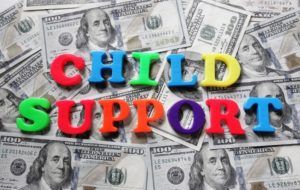 Child Support spelled in colorful letters on cash