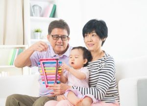 asian grand parents with crying grand daugther